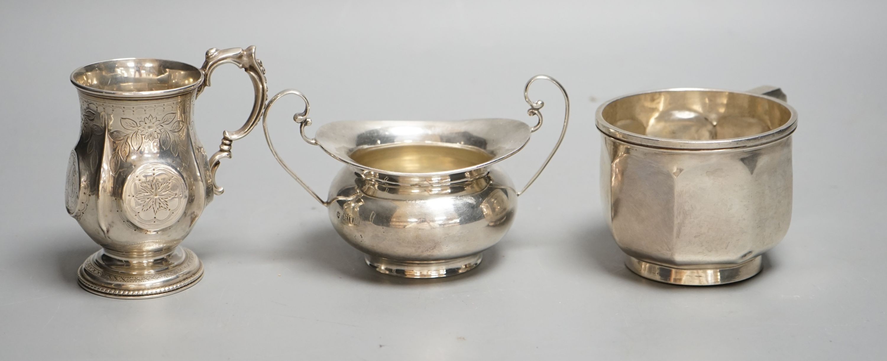 A Victorian silver christening mug, Birmingham, 1874, a later silver mug and a two handled sugar bowl